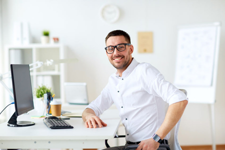 77891777 - happy smiling businessman with computer at office